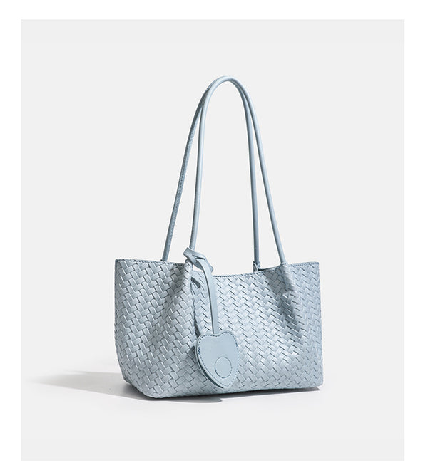 Woven leather-look tote bag in yellow with long shoulder straps, heart-shaped hanging charm, and removable inner zip pouch