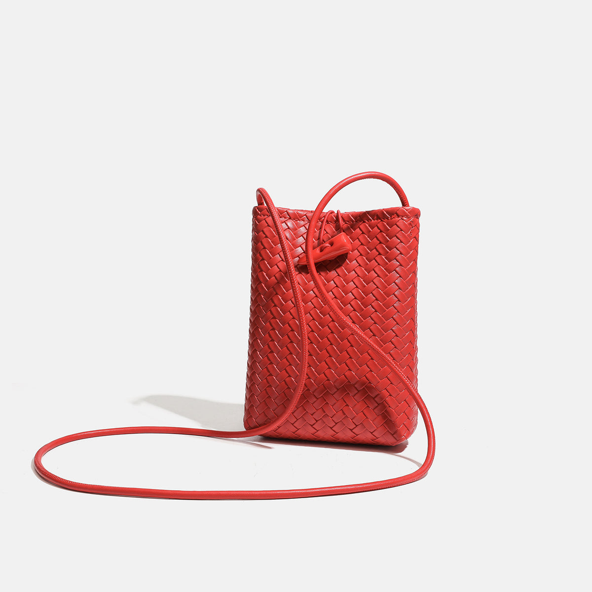Compact woven leather-look bucket crossbody pouch with toggle closure and long fixed strap, detail view 3