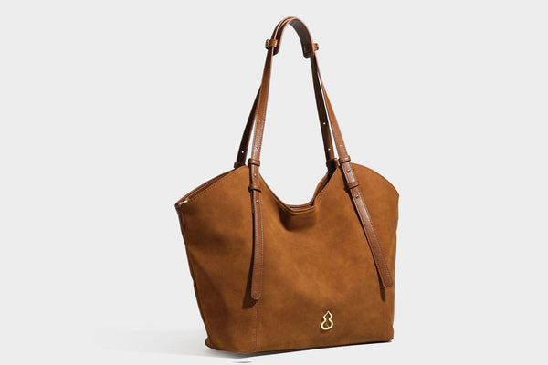 Oversized suede-finish tote shoulder bag in caramel brown with slim leather-look straps and gold-tone logo hardware, detail