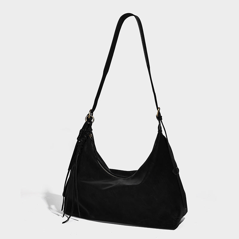 Slouchy matte-finish hobo shoulder bag with tassel trim and gold-tone hardware, front view
