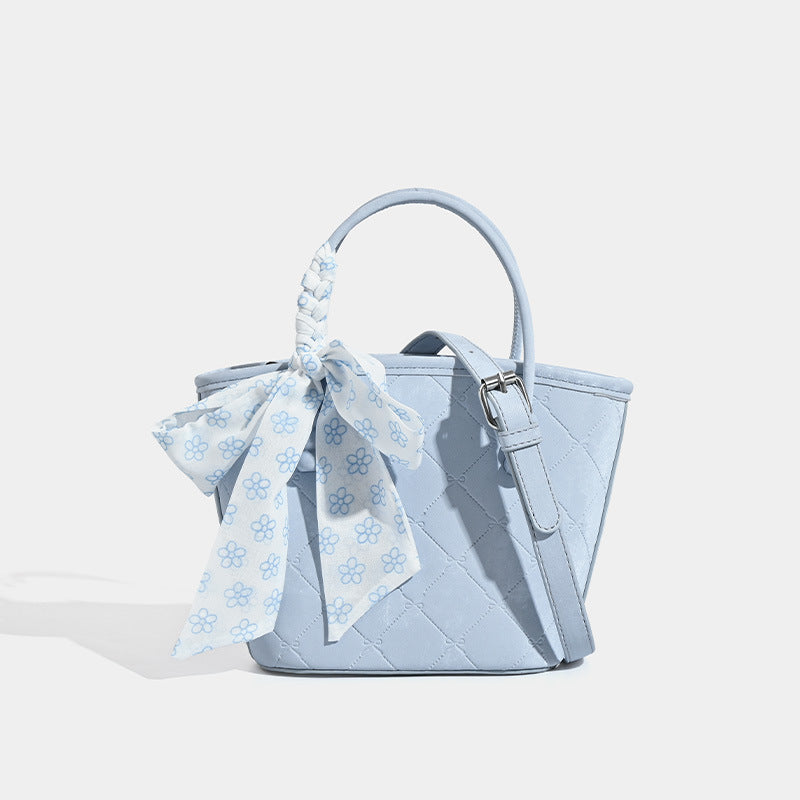 Quilted leather-look mini tote bag with printed scarf bow on braided top handle and silver-tone hardware, detail view 7