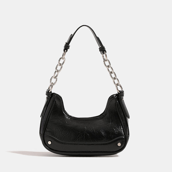 Compact crescent hobo shoulder bag in glossy burgundy leather-look finish with silver chain strap, red and green bead tassel