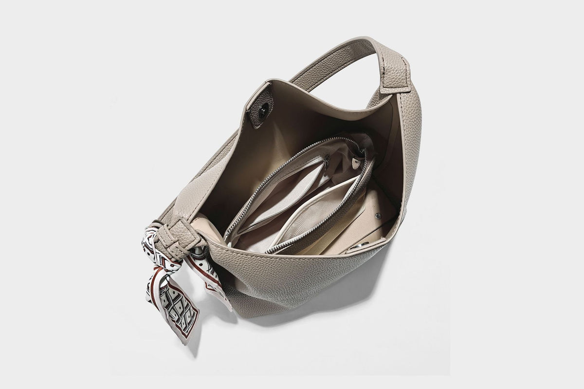 Soft slouchy hobo shoulder bag in pebbled matte finish with slim strap, silver-tone ring hardware, and knotted printed scarf