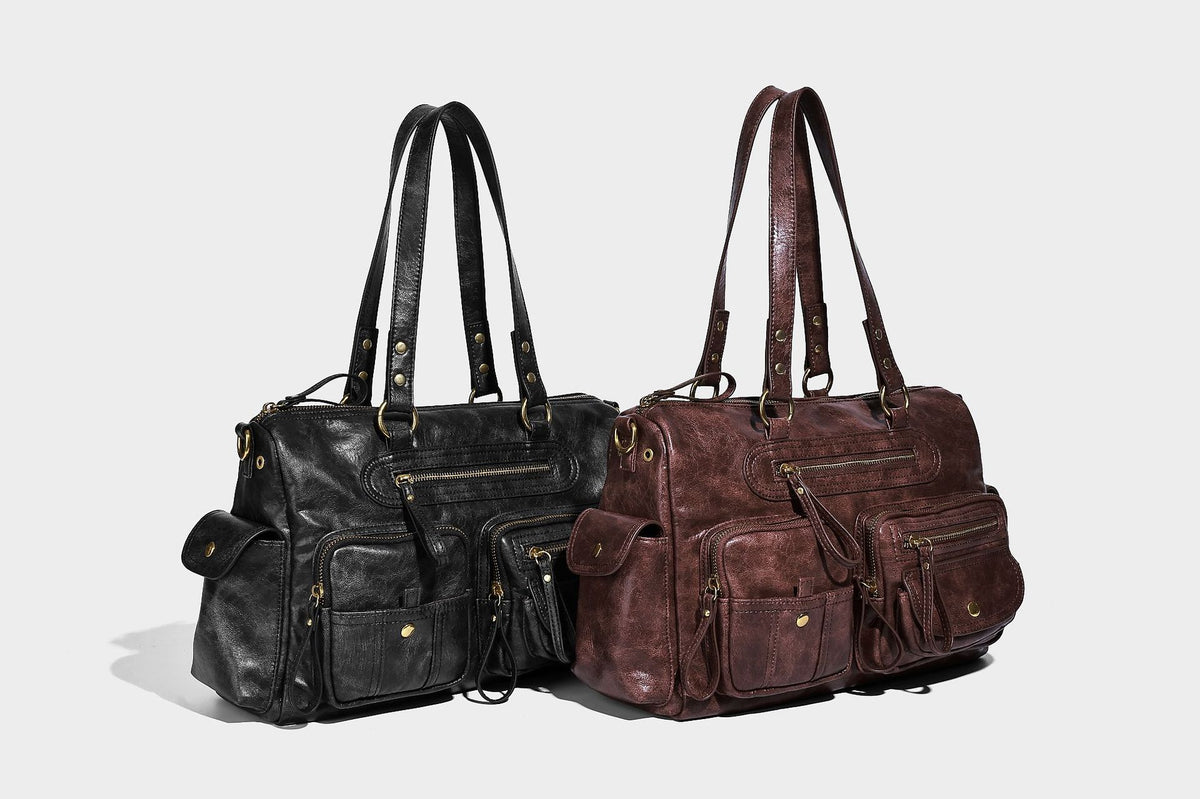 Distressed leather-look vintage satchel shoulder bag with multiple front zip pockets, dual top handles, and brass-tone