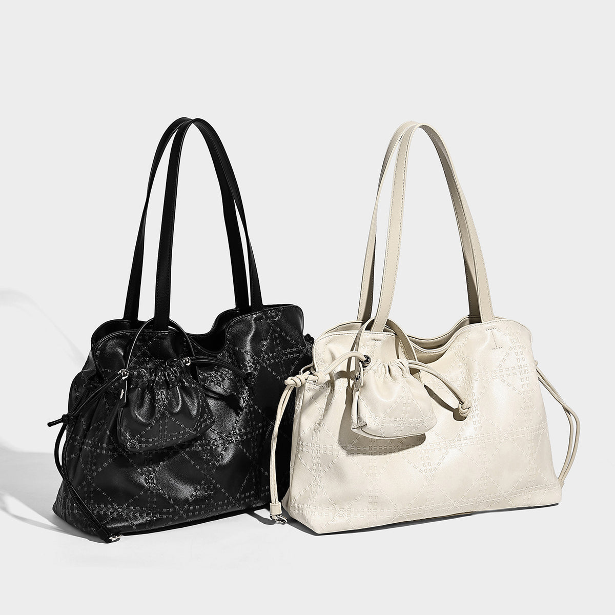 Large embossed leather-look tote shoulder bag in ivory cream with dual long straps, side drawstring cinch, and detachable