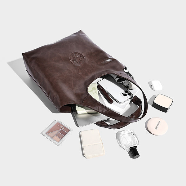 Glossy oil-wax leather-look open-top tote shoulder bag with embossed circular logo and long double straps, detail view 4