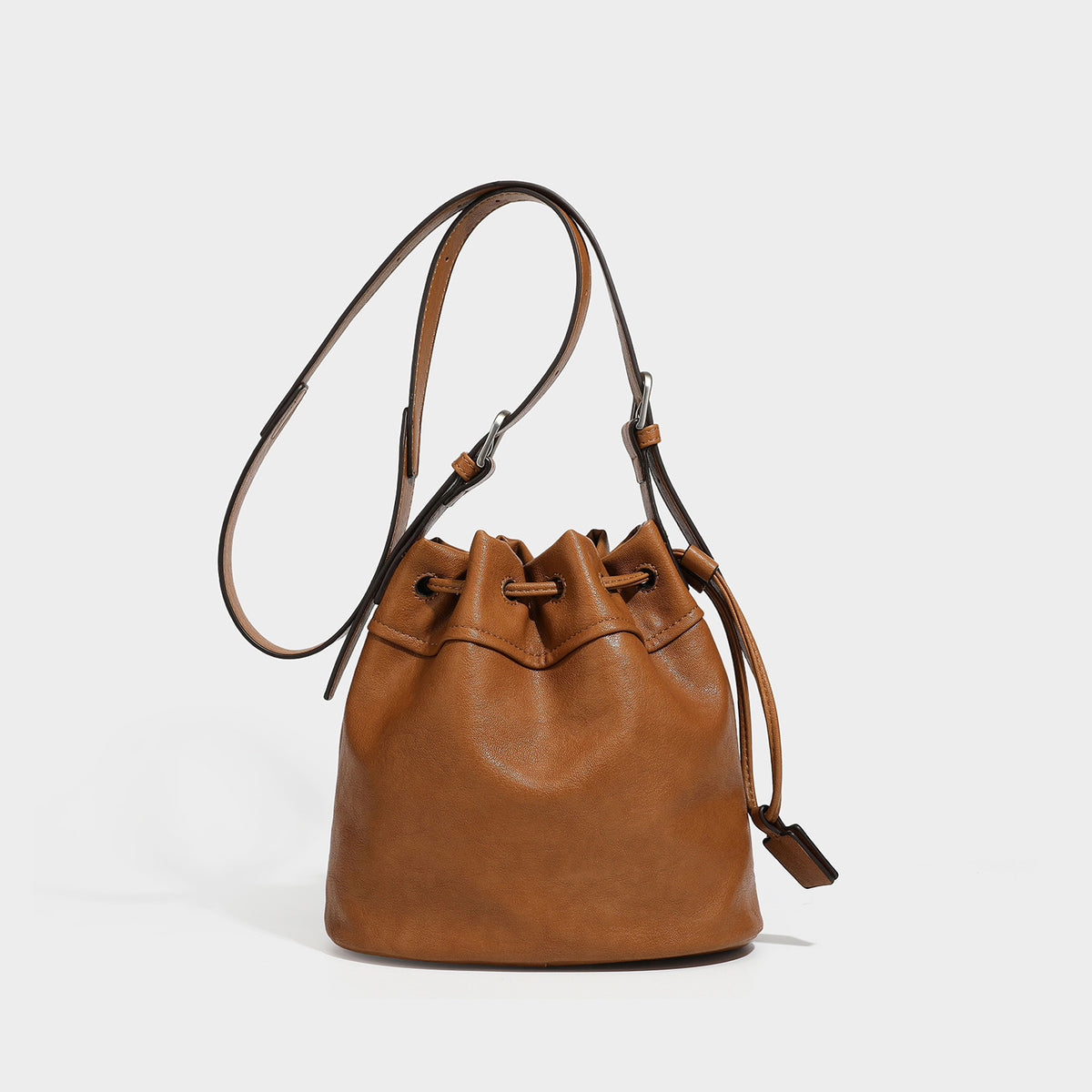 Kleine dunkelbraune Beuteltasche mit langem verstellbarem Crossbody-Riemen und silberfarbenen Beschlägen, Detailansicht 3