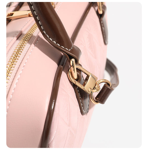 Small structured blush pink quilted diamond Boston barrel bag with brown leather-look trim, double top handles, heart accent