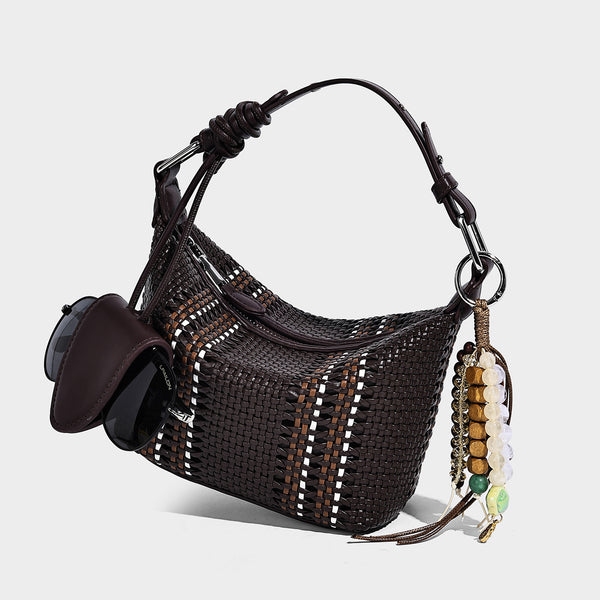 Small woven crescent shoulder bag with leather-look trim, zip closure, silver-tone ring hardware, and beaded tassel charm