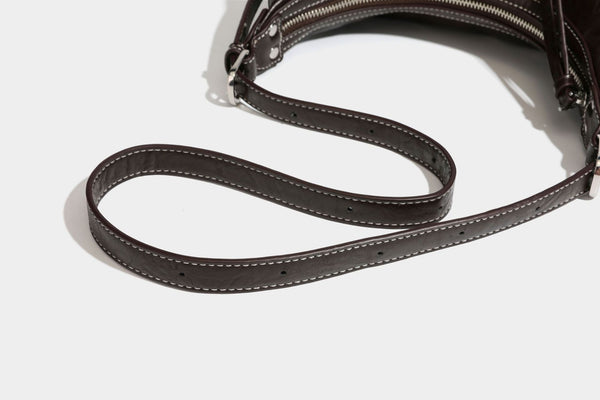 Slouchy hobo shoulder bag in glossy crinkled leather-look finish with zip-top closure and silver-tone ring hardware, detail