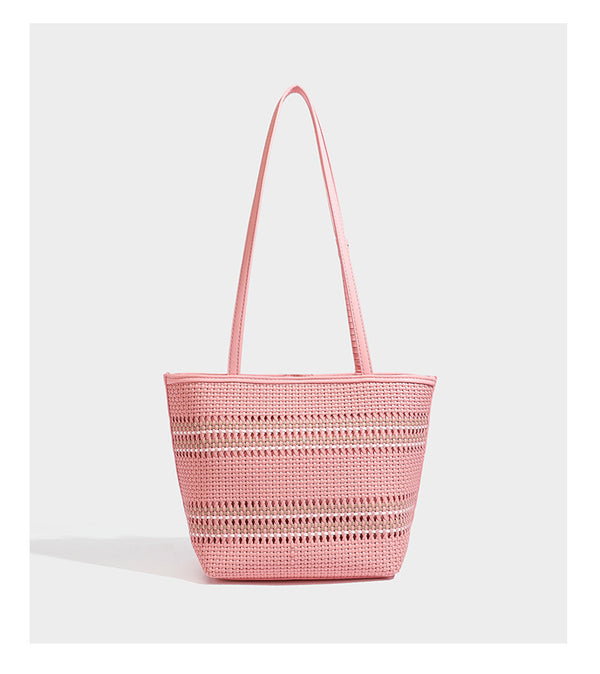 Large structured woven tote bag with striped basket-weave finish, long shoulder straps, and detachable mini pouch charm