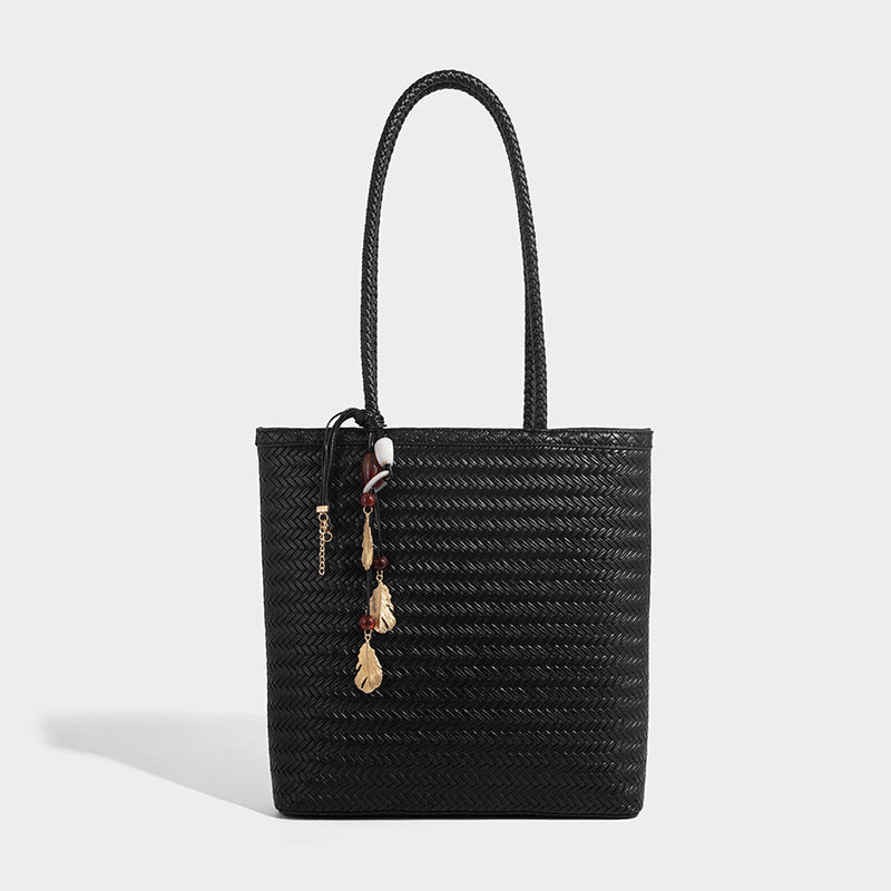 Structured woven herringbone tote bag with braided double shoulder handles in tan brown, shown with matching drawstring