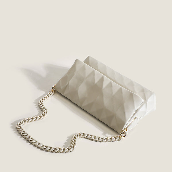 Cream white rectangular flap shoulder bag with geometric faceted surface and chunky tone-on-tone chain strap with gold-tone