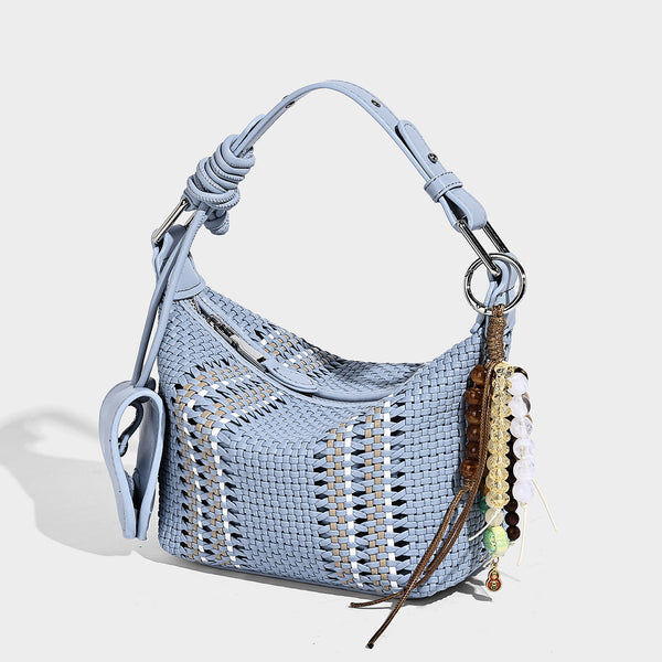 Small woven crescent shoulder bag with leather-look trim, zip closure, silver-tone ring hardware, and beaded tassel charm