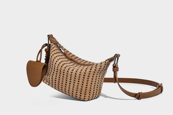 Woven crescent shoulder bag with leather-look knotted handle, zip top, attached mini pouch, and silver-tone hardware, detail