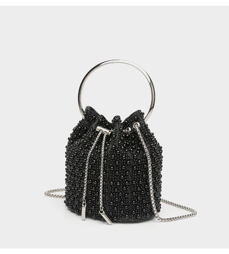 Small pearl-beaded drawstring bucket bag with silver-tone ring top handle and chain shoulder strap, detail view 16