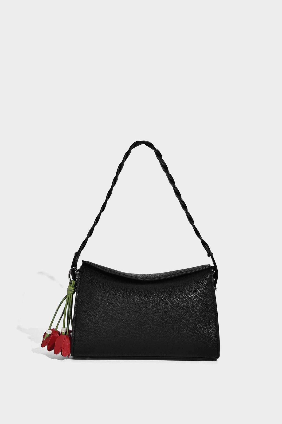 Small structured pebbled-finish shoulder bag with braided top handle, detachable crossbody strap, floral tassel charm, and