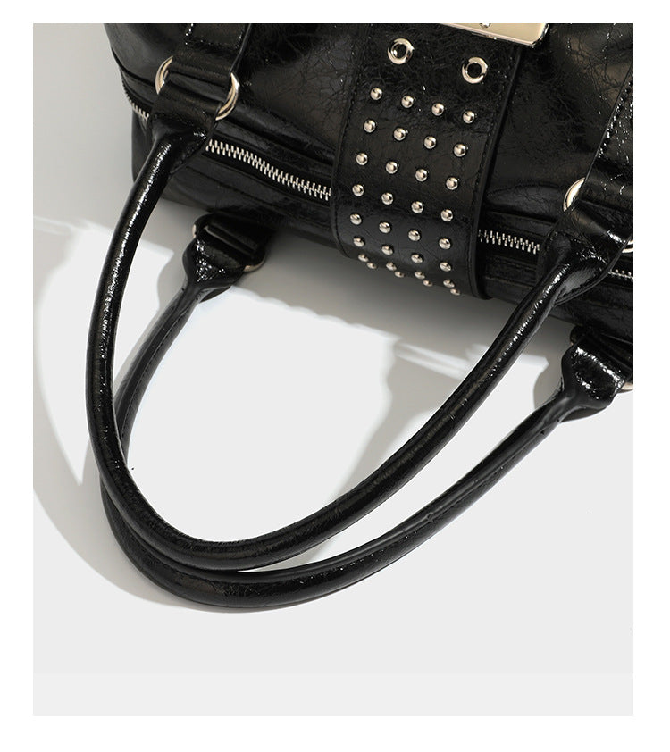 Glossy crinkled barrel handbag with silver stud buckle strap and detachable shoulder strap, detail view 19