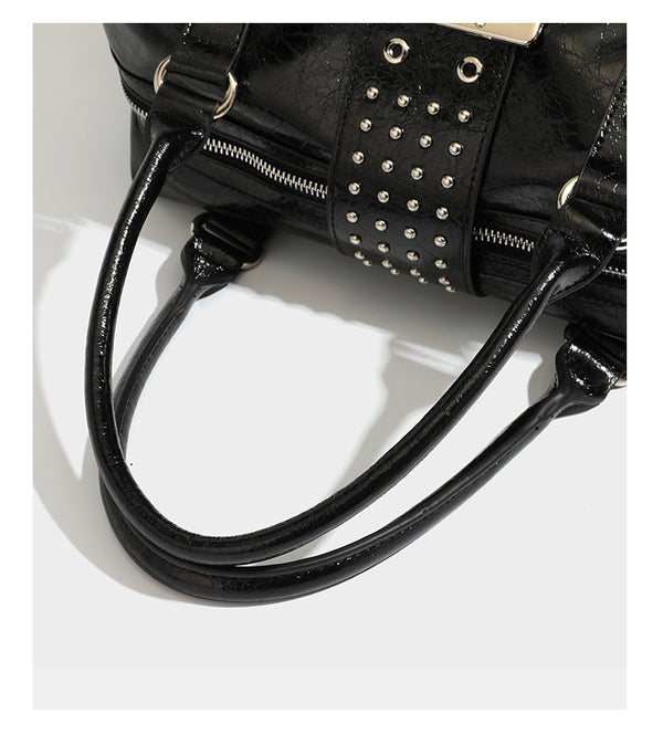 Glossy crinkled barrel handbag with silver stud buckle strap and detachable shoulder strap, detail view 19
