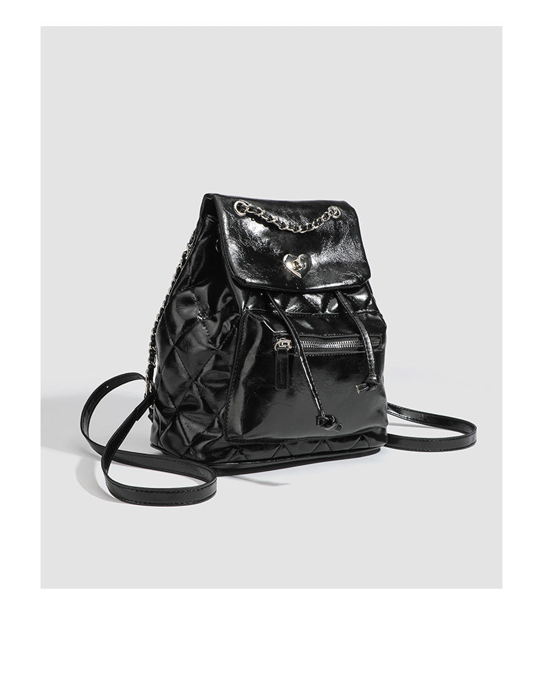 Quilted leather-look backpack with heart turn-lock clasp and woven chain handles, detail view 9