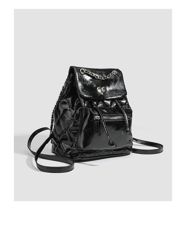 Quilted leather-look backpack with heart turn-lock clasp and woven chain handles, detail view 9