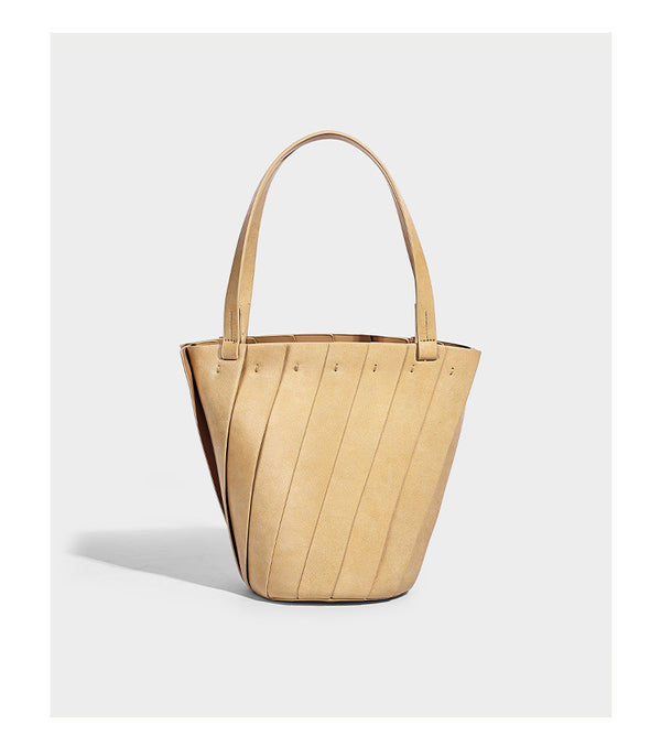 Structured bucket tote bag with vertical panel exterior, dual top handles, and detachable shoulder strap in tan leather-look