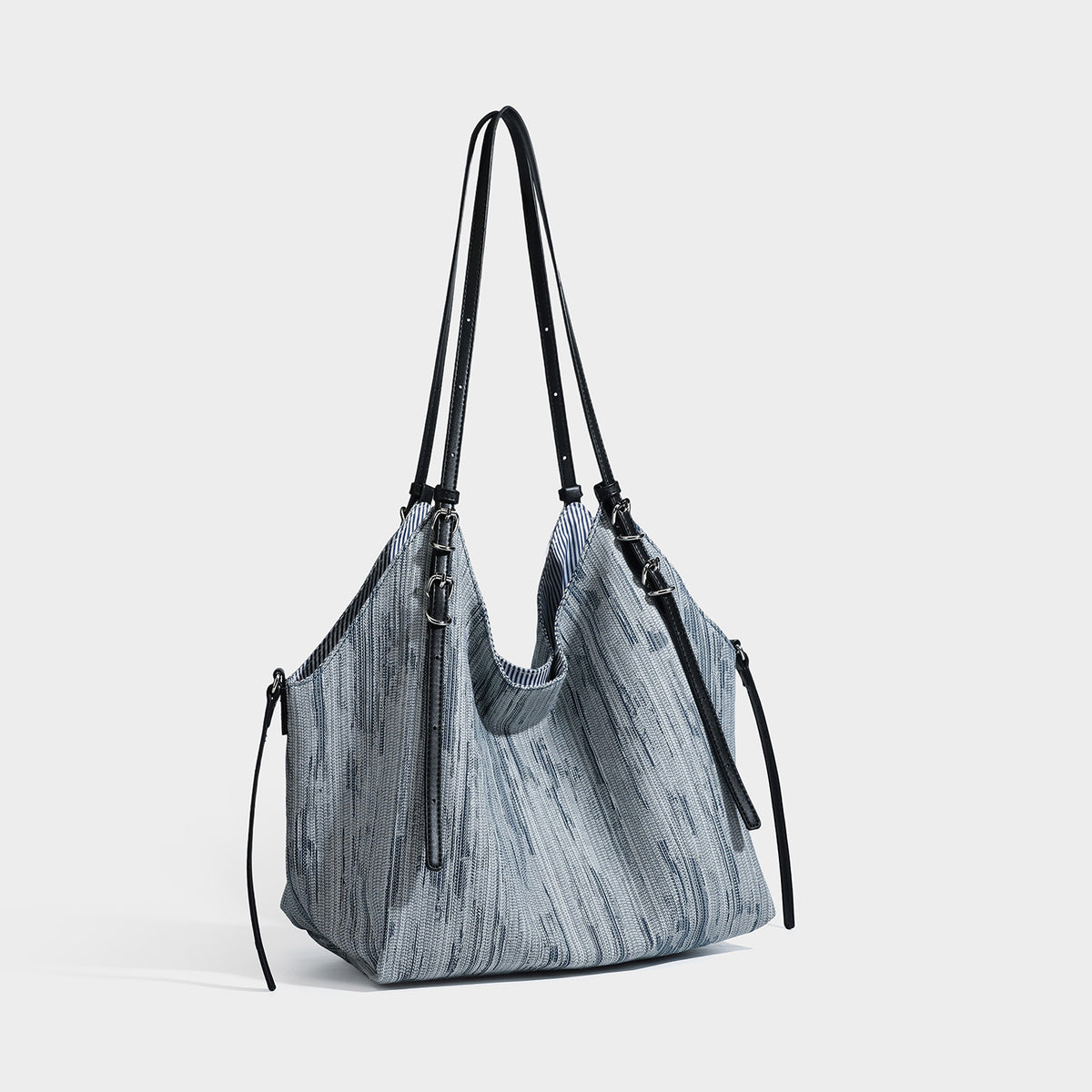 Large slouchy woven-texture shoulder tote bag with slim leather-look straps, side cinch ties, and silver-tone hardware, front