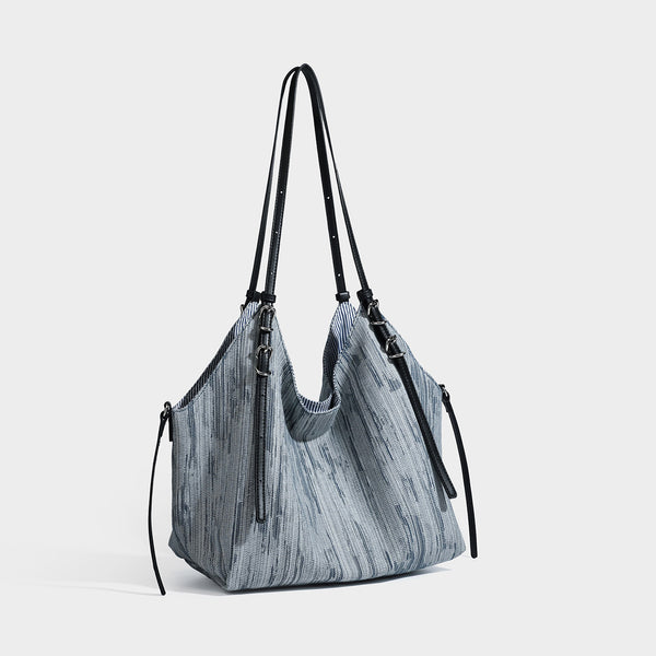Large slouchy woven-texture shoulder tote bag with slim leather-look straps, side cinch ties, and silver-tone hardware, front