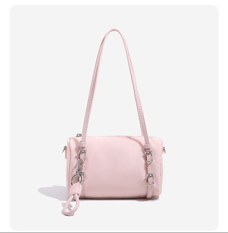 Compact nylon Boston barrel bag with zip-top closure, silver-tone hardware, dual slim handles, and detachable crossbody