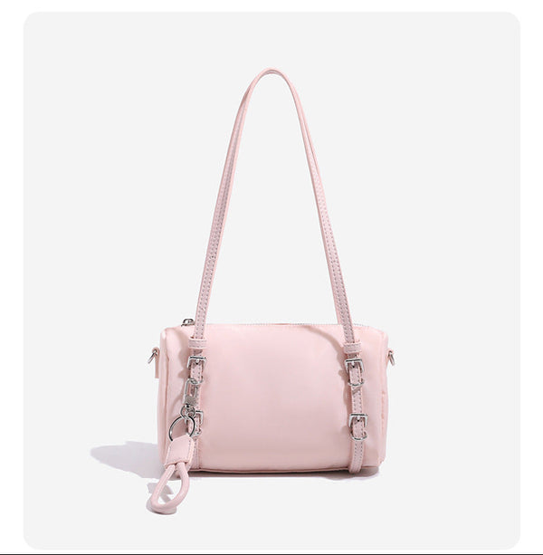 Compact nylon Boston barrel bag with zip-top closure, silver-tone hardware, dual slim handles, and detachable crossbody
