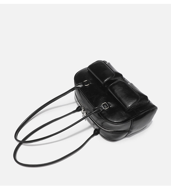 Structured glossy leather-look bowling shoulder bag with two front flap pockets, top zip closure, and long double shoulder