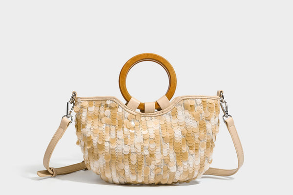 Small sequin half-moon handbag with circular wood-look ring handles and detachable leather-look shoulder strap, detail view