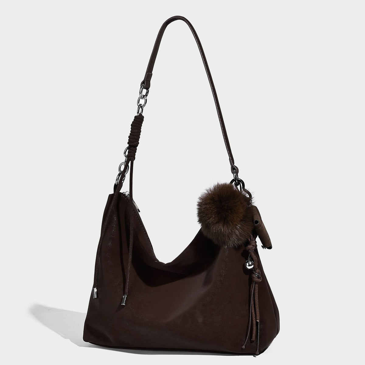 Slouchy matte-finish hobo shoulder bag with tassel cords, silver-tone hardware, and faux-fur pom charm, detail view 8