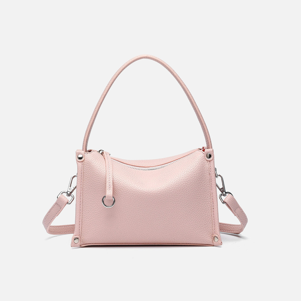 Small structured pebbled-finish convertible bag with silver corner studs, zip top, and detachable shoulder strap, detail view
