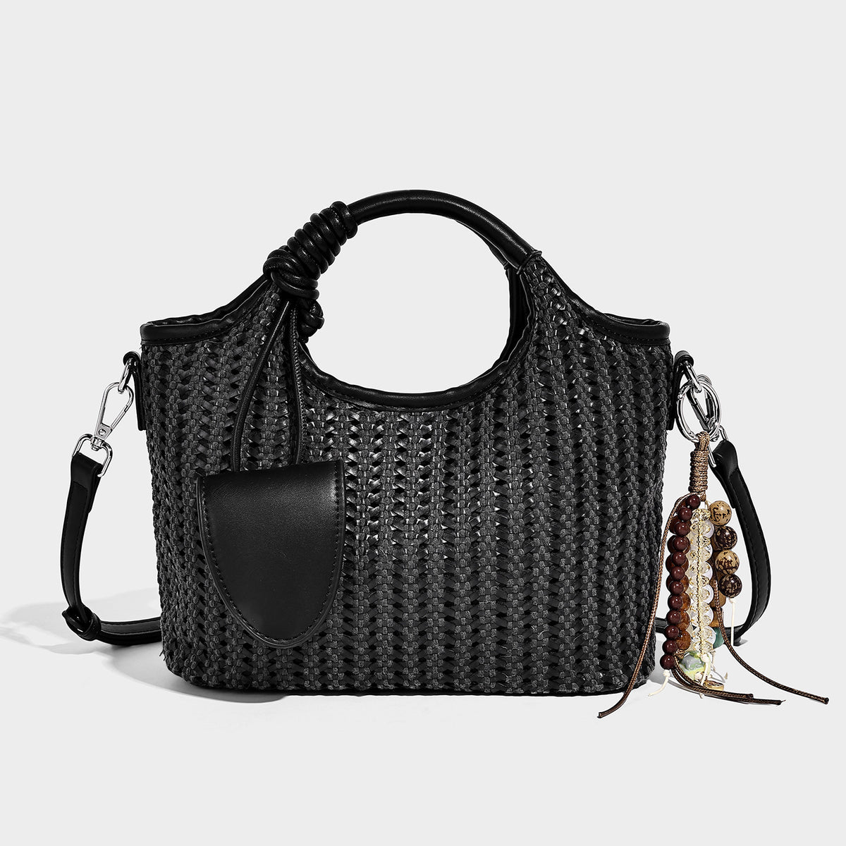 Small structured woven tote crossbody bag with ring top handle, leather-look brown trim, front patch pocket, and detachable
