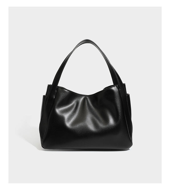 Structured glossy leather-look tote shoulder bag with dual top handles, detachable crossbody strap, side pockets, and, detail