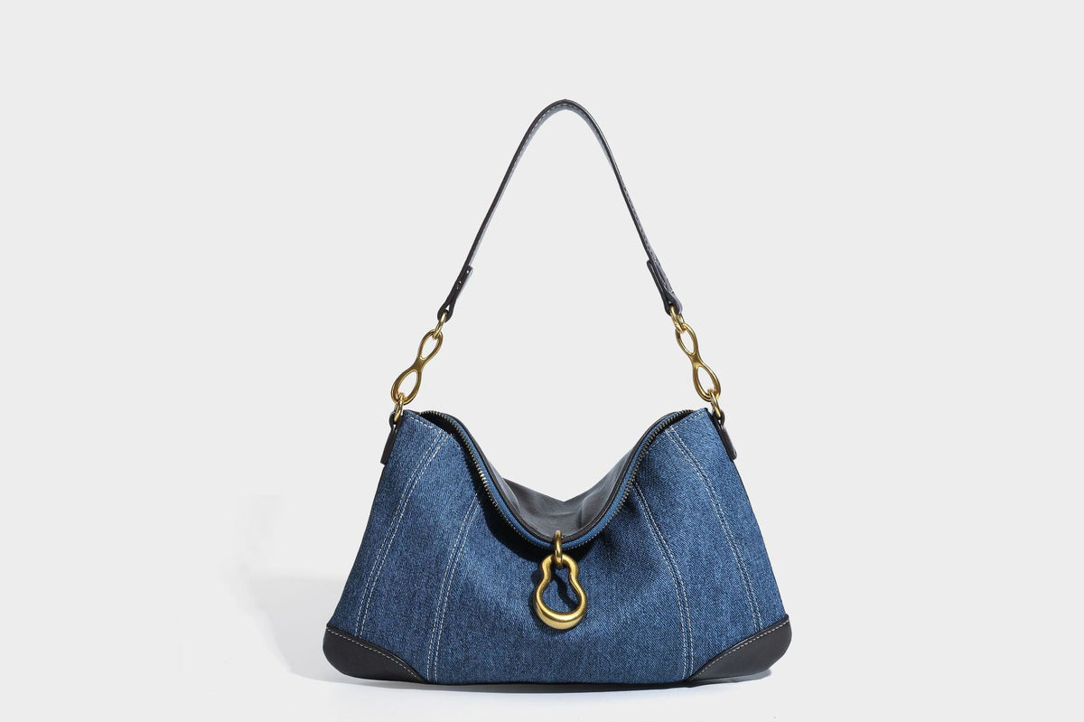 Slouchy denim shoulder bag with dark leather-look trim, gold-tone chain-link hardware, and top zipper closure, detail view 25