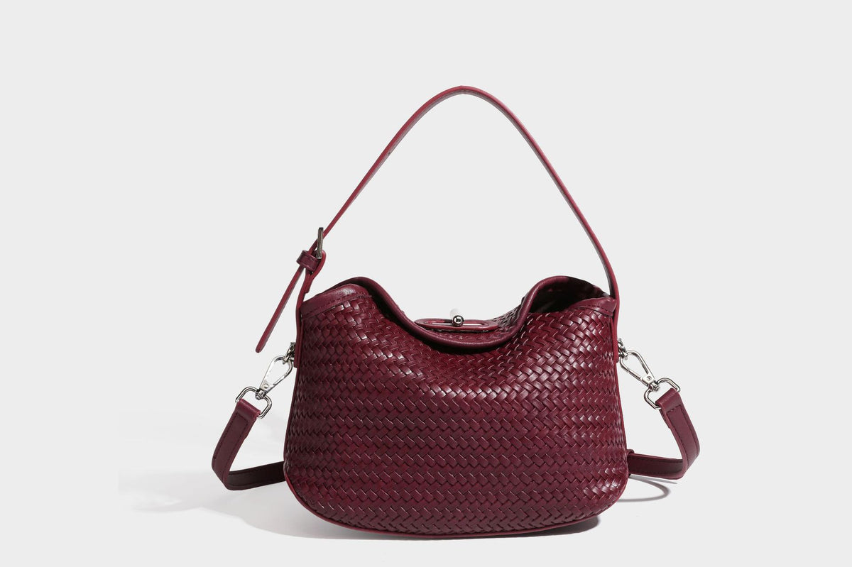 Small woven-look leather-look flap shoulder hobo bag in burgundy with silver-tone hardware and decorative tassel charm