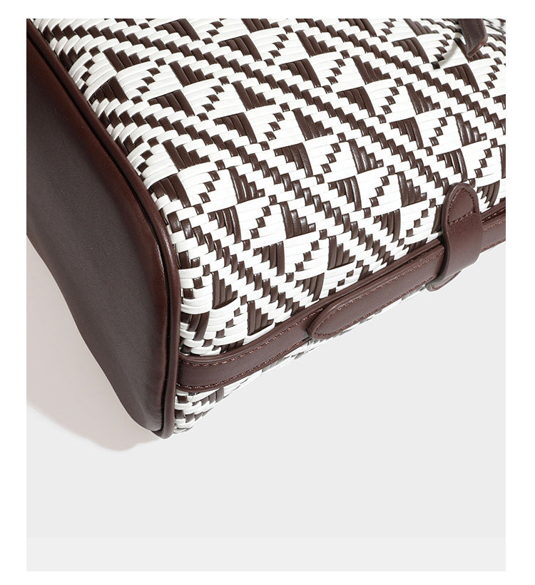 Woven geometric bucket shoulder bag in white and dark brown two-tone pattern with leather-look trim and drawstring top
