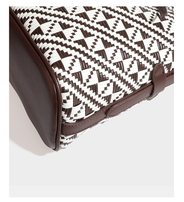 Woven geometric bucket shoulder bag in white and dark brown two-tone pattern with leather-look trim and drawstring top