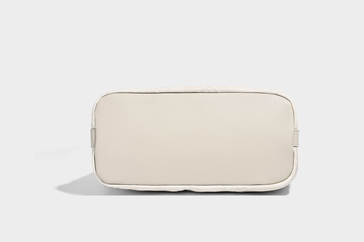 Diamond-quilted leather-look bucket shoulder bag with knotted strap accent and attached mini pouch, detail view 25