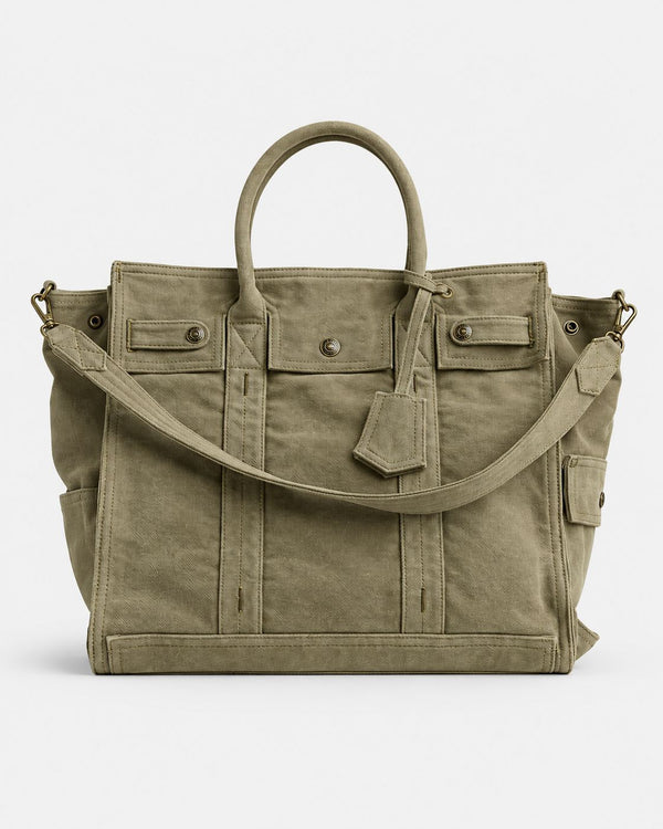 Large washed denim patchwork tote bag with snap-flap front pockets, rolled handles, and detachable shoulder strap, detail