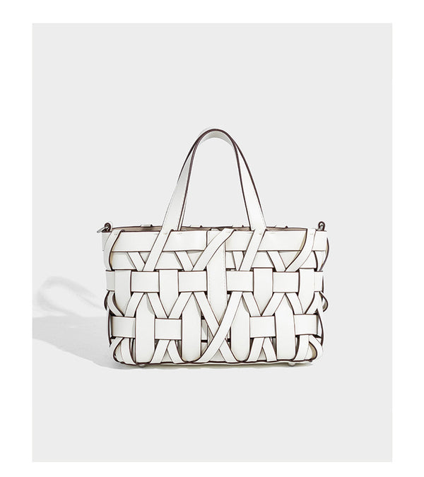Structured woven basket tote handbag with contrasting dark trim, double top handles, detachable shoulder strap, and