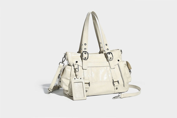 Glossy structured black tote shoulder bag with silver buckle hardware, zip pockets, dual top handles, and detachable, detail