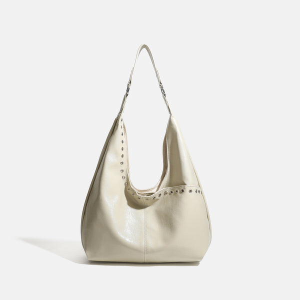 Large slouchy hobo shoulder bag with silver eyelet trim and glossy leather-look finish, detail view 8