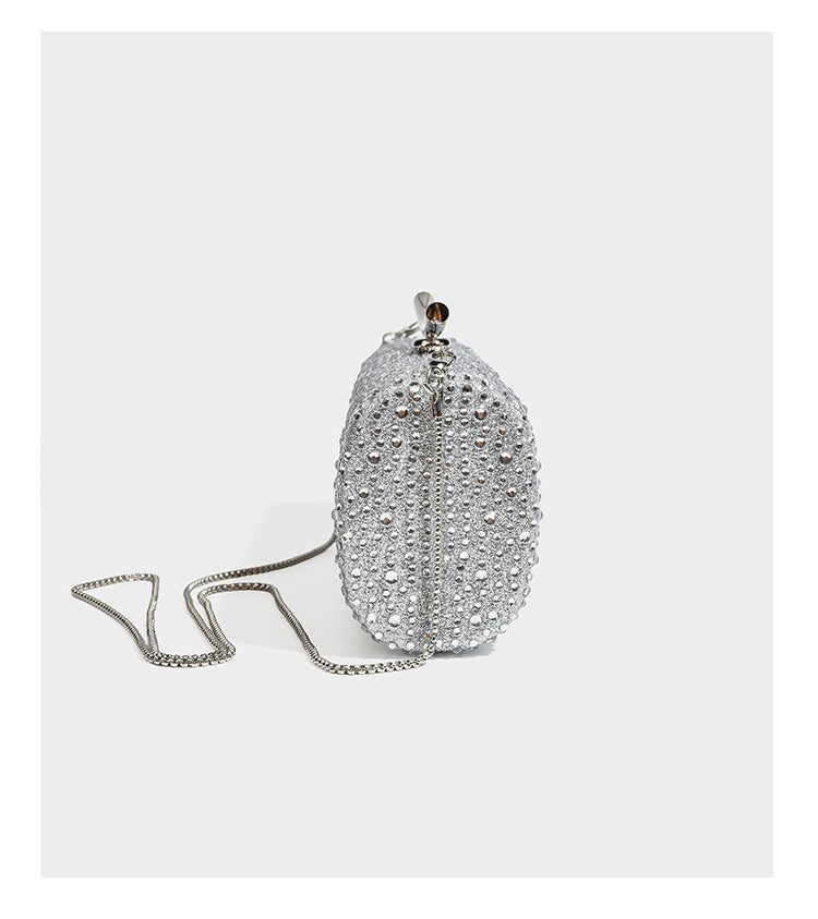 Structured rectangular hard-case clutch bag covered in all-over rhinestone crystal embellishment with curved kiss-lock top
