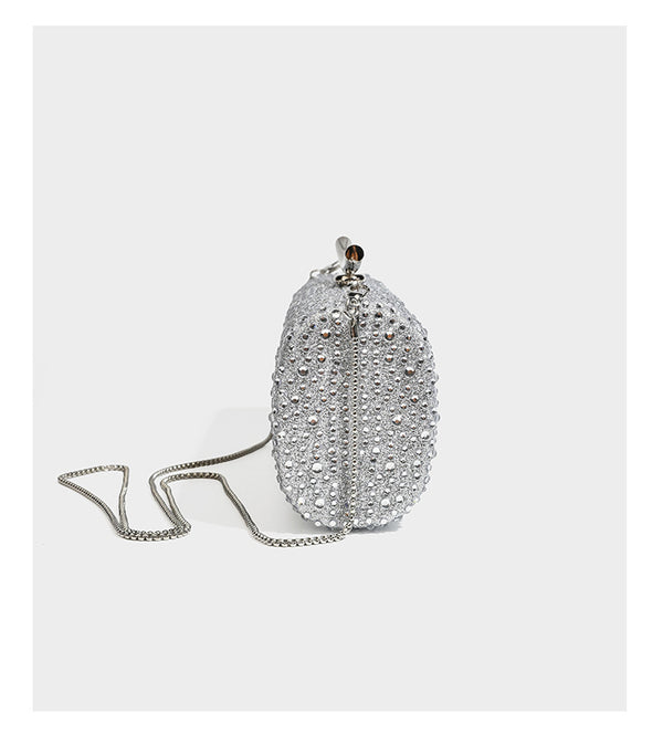 Structured rectangular hard-case clutch bag covered in all-over rhinestone crystal embellishment with curved kiss-lock top