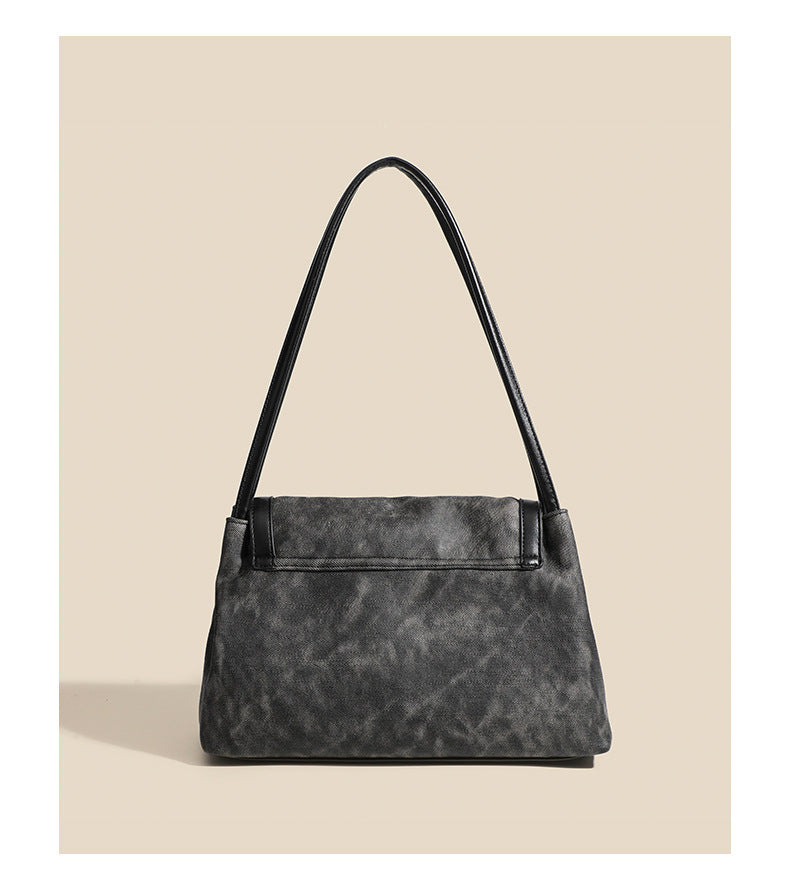 Washed leather-look shoulder tote bag with silver butterfly emblem and buckle hardware, detail view 10