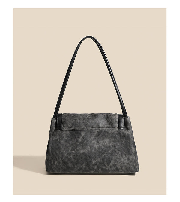 Washed leather-look shoulder tote bag with silver butterfly emblem and buckle hardware, detail view 10