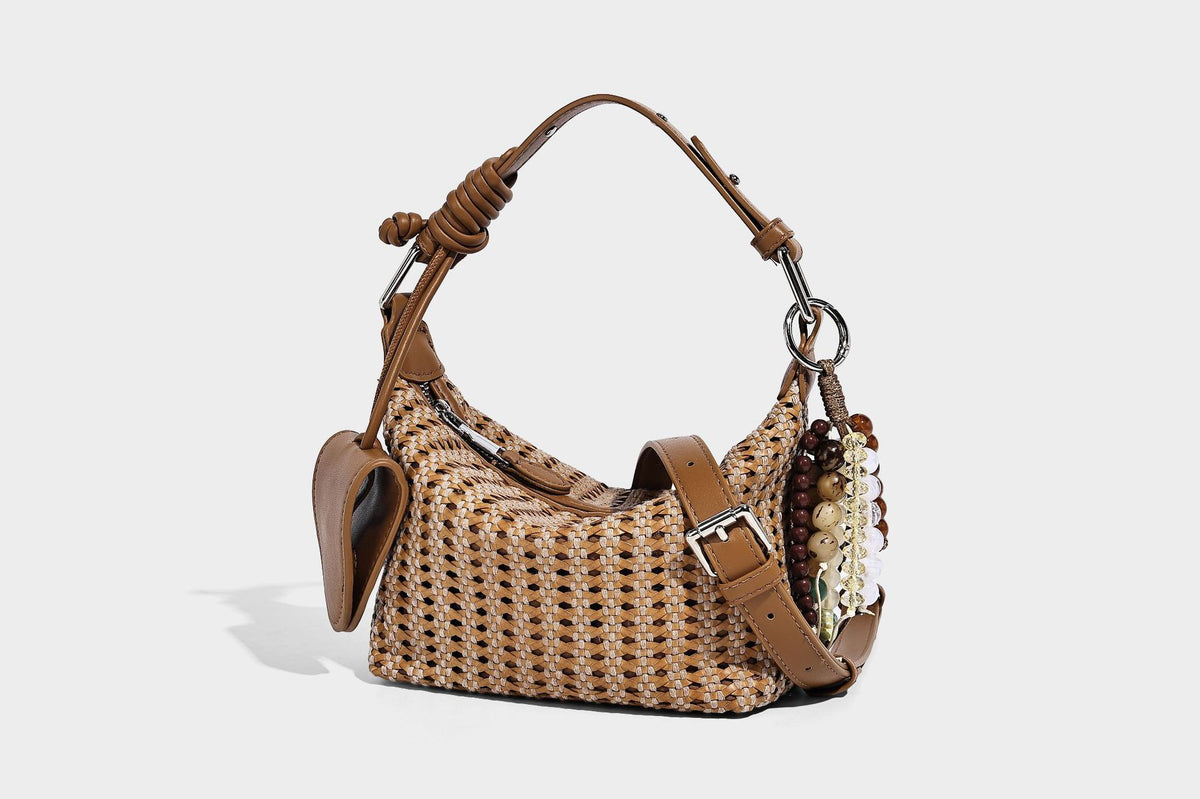 Woven crescent shoulder bag with leather-look knotted handle, zip top, attached mini pouch, and silver-tone hardware, detail